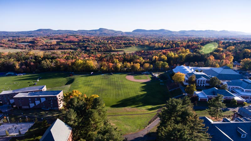 aerial view of Amherst College campus in autumn showing Mount Holyoke range in distance